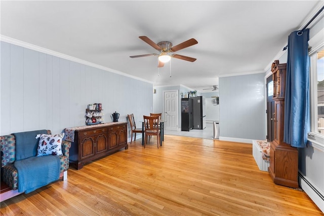 15 Wayland St, East Providence, RI 02914 - sitting room featuring a baseboard heating unit, ceiling fan, light wood-type flooring, and ornamental molding