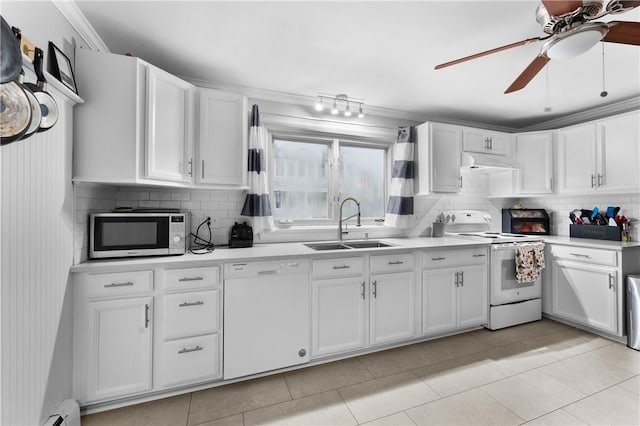 15 Wayland St, East Providence, RI 02914 - kitchen with white appliances, under cabinet range hood, tasteful backsplash, light countertops, and crown molding