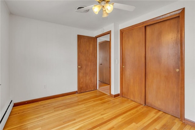 37 Joseph St, Providence, RI 02904 - unfurnished bedroom featuring baseboard heating, light wood finished floors, a closet, and a ceiling fan