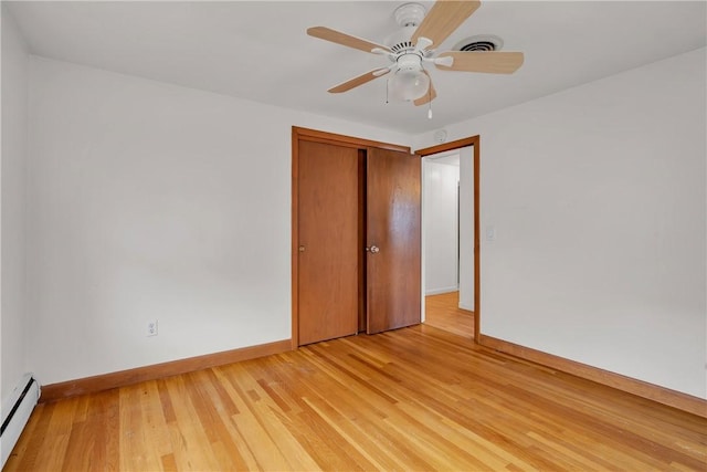 37 Joseph St, Providence, RI 02904 - empty room with a baseboard radiator, light wood-style floors, and ceiling fan
