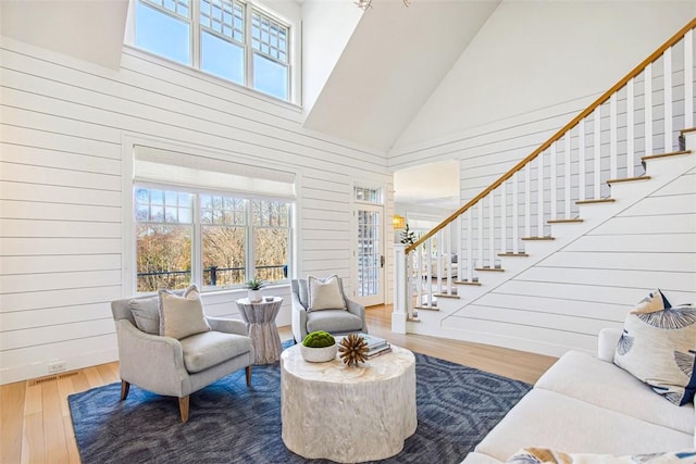 7 Spring Pond Rd, Westerly, RI 02891 - living room featuring high vaulted ceiling, stairway, wood finished floors, and wooden walls