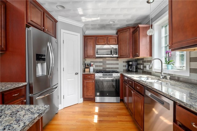 3560 Diamond Hill Rd, Cumberland, RI 02864 - kitchen featuring appliances with stainless steel finishes, ornamental molding, decorative backsplash, light wood-style floors, and hanging light fixtures