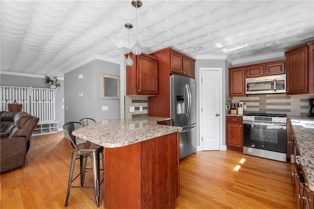 3560 Diamond Hill Rd, Cumberland, RI 02864 - kitchen featuring stainless steel appliances, open floor plan, ornamental molding, a peninsula, and light wood-type flooring