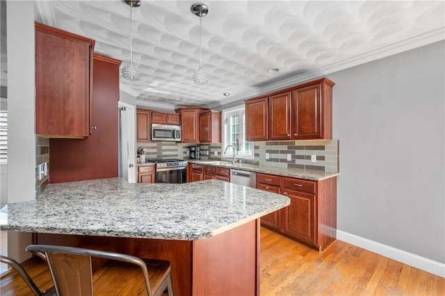 3560 Diamond Hill Rd, Cumberland, RI 02864 - kitchen with stainless steel appliances, crown molding, a peninsula, tasteful backsplash, and light stone countertops