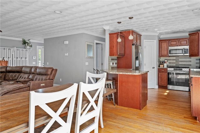 3560 Diamond Hill Rd, Cumberland, RI 02864 - kitchen featuring stainless steel appliances, a peninsula, tasteful backsplash, light wood-style flooring, and light stone counters
