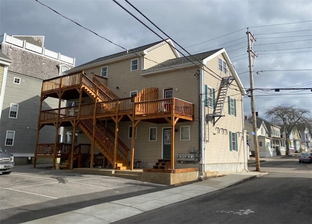 621 Thames St Unit C, Newport, RI 02840 - rear view of property featuring stairs, a wooden deck, and a residential view