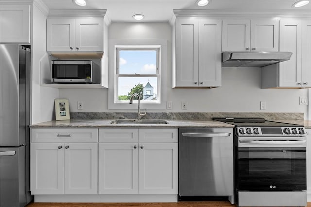 621 Thames St Unit C, Newport, RI 02840 - kitchen with appliances with stainless steel finishes, under cabinet range hood, white cabinetry, recessed lighting, and light stone countertops