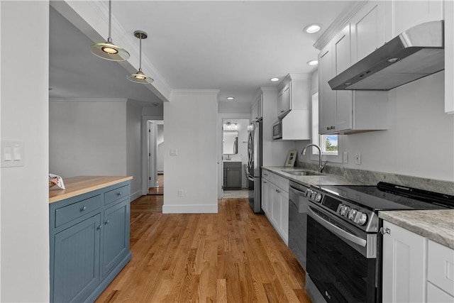 621 Thames St Unit C, Newport, RI 02840 - kitchen with appliances with stainless steel finishes, under cabinet range hood, light countertops, hanging light fixtures, and white cabinetry