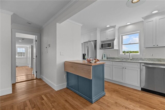 621 Thames St Unit C, Newport, RI 02840 - kitchen featuring stainless steel appliances, light wood-type flooring, white cabinets, crown molding, and recessed lighting