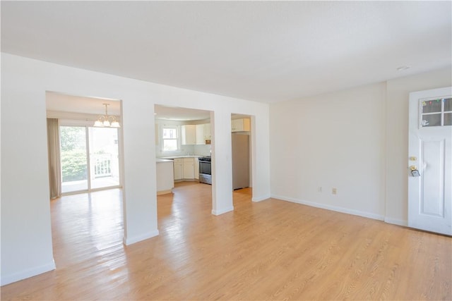 22 Gage St Unit 101, Providence, RI 02909 - unfurnished living room featuring a chandelier and light wood-style flooring