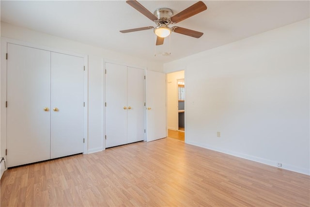 22 Gage St Unit 101, Providence, RI 02909 - unfurnished bedroom with two closets, light wood-style flooring, and ceiling fan