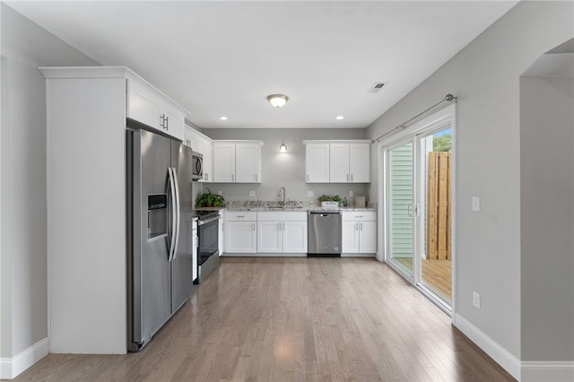 6 Jupiter Ln Unit B, Richmond, RI 02898 - kitchen featuring stainless steel appliances, light wood-type flooring, white cabinets, light stone countertops, and recessed lighting
