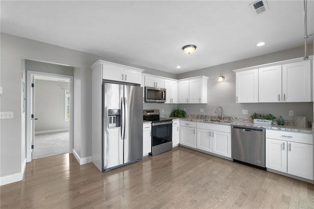 6 Jupiter Ln Unit B, Richmond, RI 02898 - kitchen featuring appliances with stainless steel finishes, recessed lighting, light wood finished floors, white cabinetry, and light stone counters