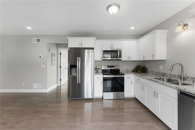 6 Jupiter Ln Unit B, Richmond, RI 02898 - kitchen with stainless steel appliances, light stone counters, wood finished floors, white cabinets, and recessed lighting