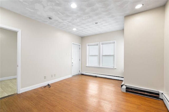 423 Pine St, Central Falls, RI 02863 - empty room with baseboard heating, wood finished floors, and recessed lighting
