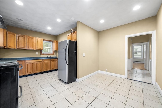 423 Pine St, Central Falls, RI 02863 - kitchen featuring freestanding refrigerator, stove, plenty of natural light, recessed lighting, and light tile patterned floors