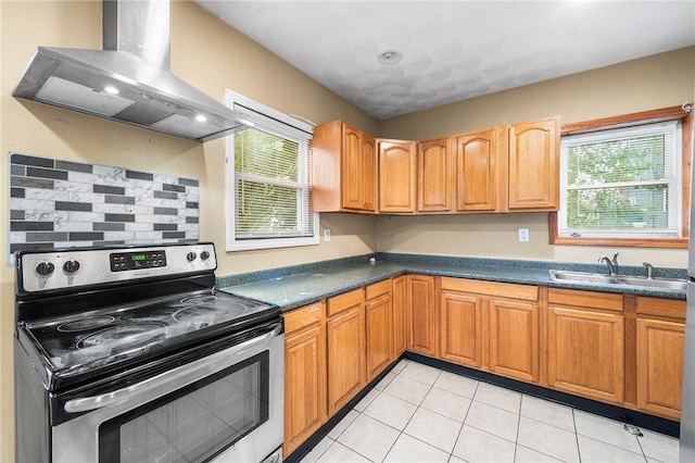 423 Pine St, Central Falls, RI 02863 - kitchen featuring electric stove, wall chimney range hood, healthy amount of natural light, and dark countertops