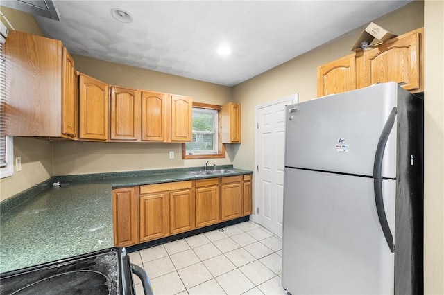 423 Pine St, Central Falls, RI 02863 - kitchen with freestanding refrigerator, dark countertops, black electric range, light tile patterned flooring, and recessed lighting