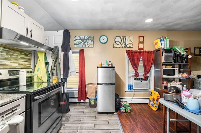 423 Pine St, Central Falls, RI 02863 - kitchen featuring appliances with stainless steel finishes, under cabinet range hood, a baseboard radiator, light wood-style flooring, and recessed lighting