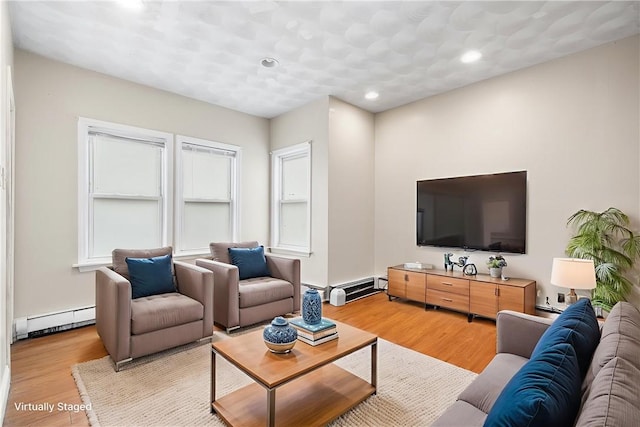 423 Pine St, Central Falls, RI 02863 - living area with a baseboard heating unit, light wood-style flooring, and recessed lighting