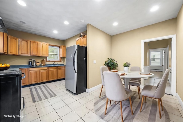 423 Pine St, Central Falls, RI 02863 - kitchen featuring freestanding refrigerator, black range oven, recessed lighting, light tile patterned floors, and dark countertops