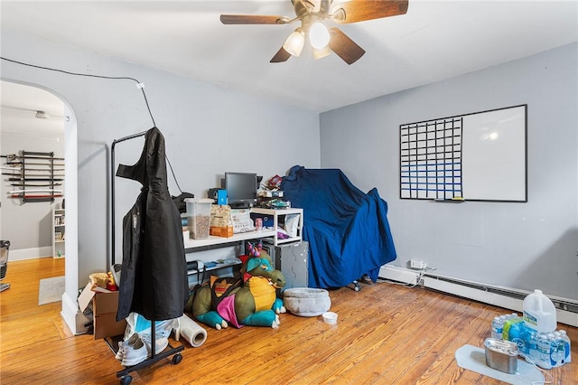 9 Nickerson St, Pawtucket, RI 02860 - bedroom with arched walkways, wood finished floors, a baseboard heating unit, and a ceiling fan