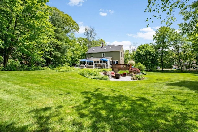 2470 W St, Wrentham, MA 02093 - rear view of property featuring a patio area, a sunroom, a yard, and a wooden deck