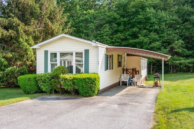 29 Cantaberry Ln, Coventry, RI 02816 - view of front of property featuring driveway, a front lawn, and a carport