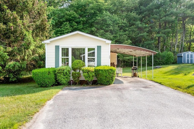 29 Cantaberry Ln, Coventry, RI 02816 - view of front of home featuring a storage unit, a front yard, driveway, and an attached carport