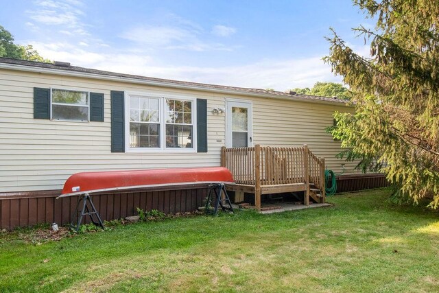 29 Cantaberry Ln, Coventry, RI 02816 - rear view of house with a yard and a deck