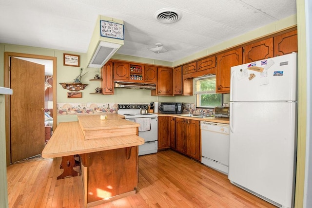 29 Cantaberry Ln, Coventry, RI 02816 - kitchen with white appliances, under cabinet range hood, brown cabinets, light wood-type flooring, and light countertops
