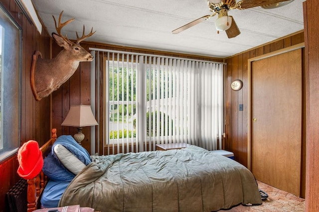 29 Cantaberry Ln, Coventry, RI 02816 - bedroom featuring wood walls, multiple windows, and ceiling fan