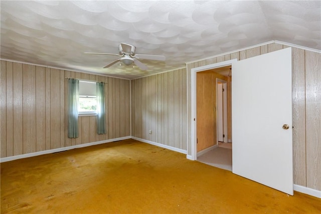 14 Meadow View Dr, Smithfield, RI 02917 - spare room featuring ceiling fan, carpet flooring, and wood walls