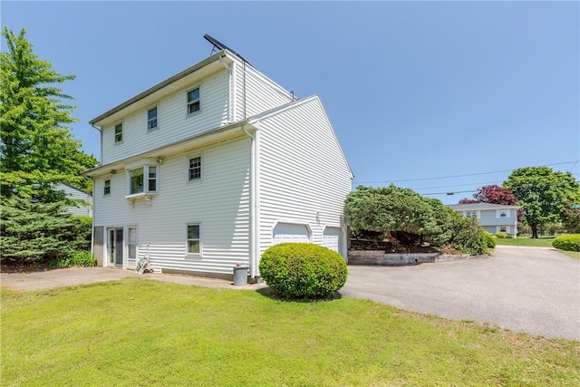 14 Meadow View Dr, Smithfield, RI 02917 - view of home's exterior featuring a yard, a garage, and driveway