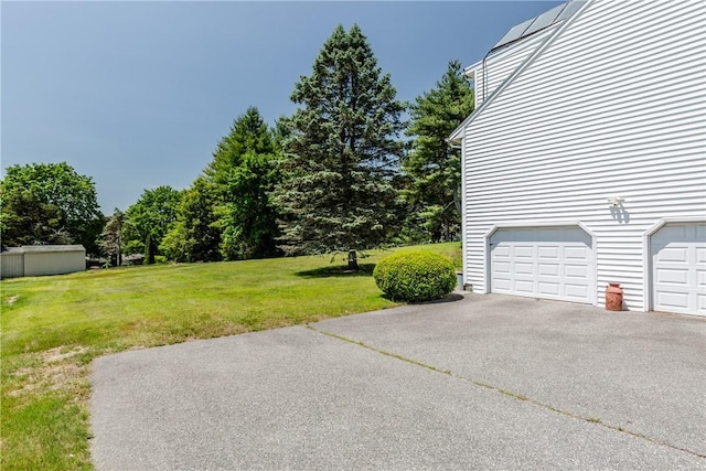 14 Meadow View Dr, Smithfield, RI 02917 - view of green lawn featuring driveway and an attached garage