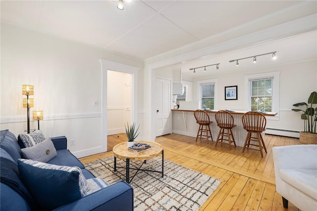 43 Cherry Ln Unit B, South Kingstown, RI 02879 - living room featuring a baseboard heating unit, rail lighting, and light wood-style floors