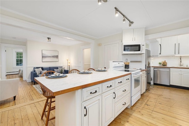 43 Cherry Ln Unit B, South Kingstown, RI 02879 - kitchen featuring white appliances, open floor plan, light wood finished floors, white cabinetry, and a baseboard heating unit