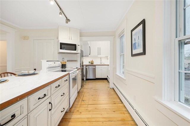 43 Cherry Ln Unit B, South Kingstown, RI 02879 - kitchen featuring white appliances, white cabinetry, light wood finished floors, light countertops, and rail lighting