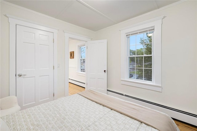 43 Cherry Ln Unit B, South Kingstown, RI 02879 - unfurnished bedroom with a baseboard radiator, ornamental molding, and wood finished floors