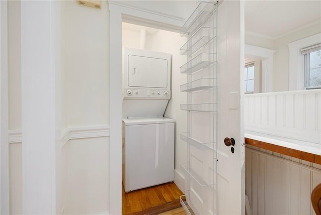 43 Cherry Ln Unit B, South Kingstown, RI 02879 - laundry area with stacked washer / drying machine, ornamental molding, and light wood-type flooring