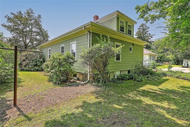 129 Ash St, Warwick, RI 02888 - view of home's exterior featuring a yard and a chimney