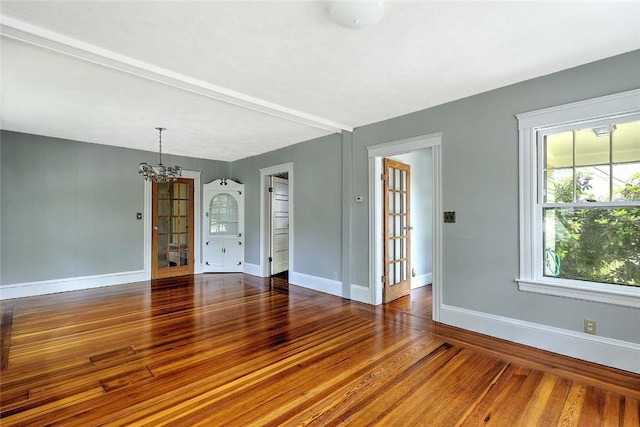 129 Ash St, Warwick, RI 02888 - spare room featuring wood finished floors and a chandelier