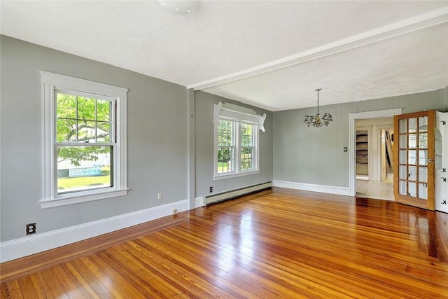 129 Ash St, Warwick, RI 02888 - unfurnished room with a baseboard heating unit, hardwood / wood-style flooring, a chandelier, and french doors