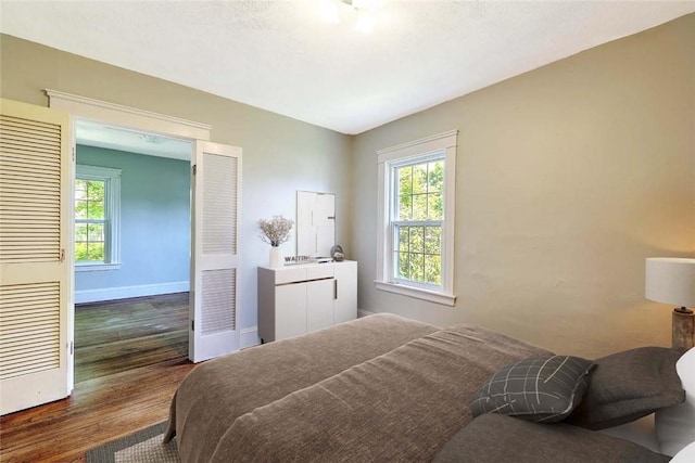 129 Ash St, Warwick, RI 02888 - bedroom with dark wood-style flooring and multiple windows
