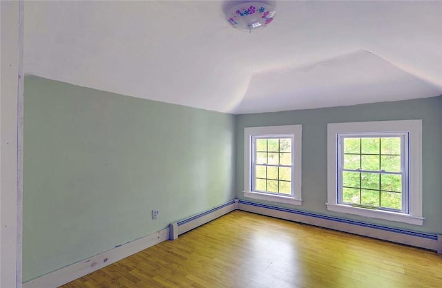 129 Ash St, Warwick, RI 02888 - empty room with wood finished floors and a baseboard heating unit