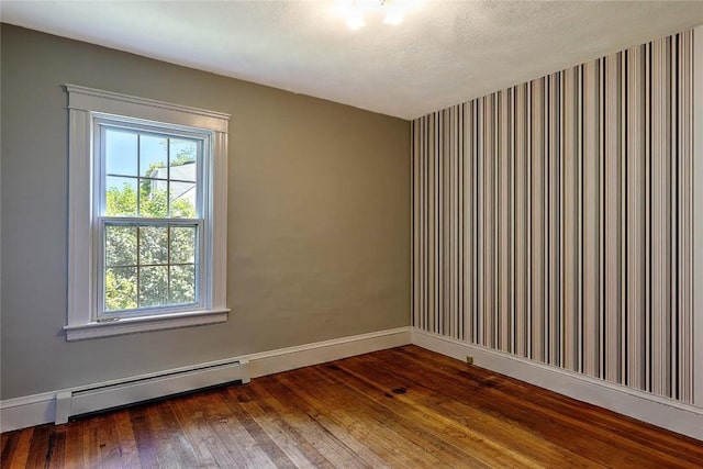 129 Ash St, Warwick, RI 02888 - spare room featuring hardwood / wood-style flooring and baseboard heating