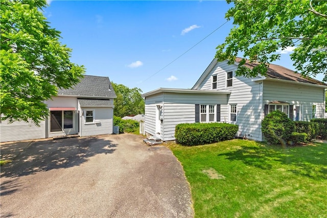 87 Gough Ave, West Warwick, RI 02893 - view of front facade featuring driveway and a front lawn