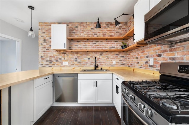 122 Willow St, Providence, RI 02909 - kitchen with appliances with stainless steel finishes, open shelves, white cabinets, hanging light fixtures, and dark wood finished floors