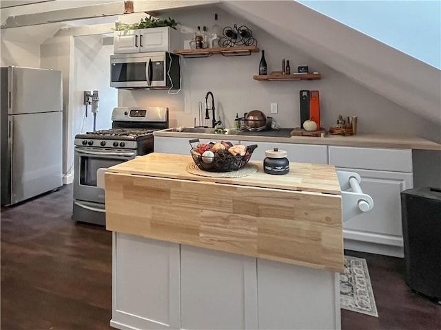 122 Willow St, Providence, RI 02909 - kitchen with stainless steel appliances, white cabinets, a center island, open shelves, and butcher block counters