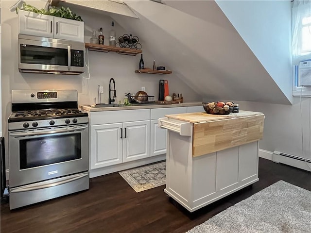 122 Willow St, Providence, RI 02909 - kitchen with appliances with stainless steel finishes, white cabinetry, dark wood finished floors, baseboard heating, and lofted ceiling